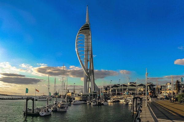 How can visitors explore the historic ships in Portsmouth without high costs?